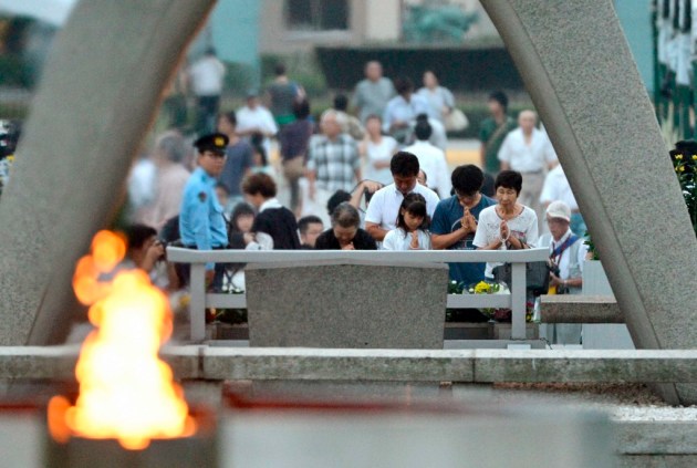 People pray for the victims of the 1945 atomic bombing, in the Peace Memorial Park in Hiroshima