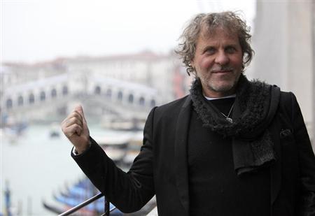 Founder of Diesel clothing company Renzo Rosso gestures as he poses in front of Rialto Bridge in Venice