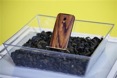 File photo of a phone with a wooden back resting in a display at a launch event for Motorola's new Moto X phone in New York