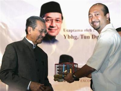 File photo of Mukhriz Mahathir receiving memento from father Mahathir Mohamad, in Petaling Jaya