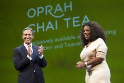 Howard Schultz announces the new Teavana Oprah Chai Tea with Oprah Winfrey during the company's annual shareholders meeting in Seattle